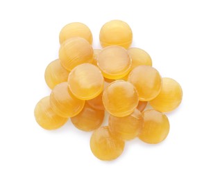 Photo of Many yellow cough drops on white background, top view