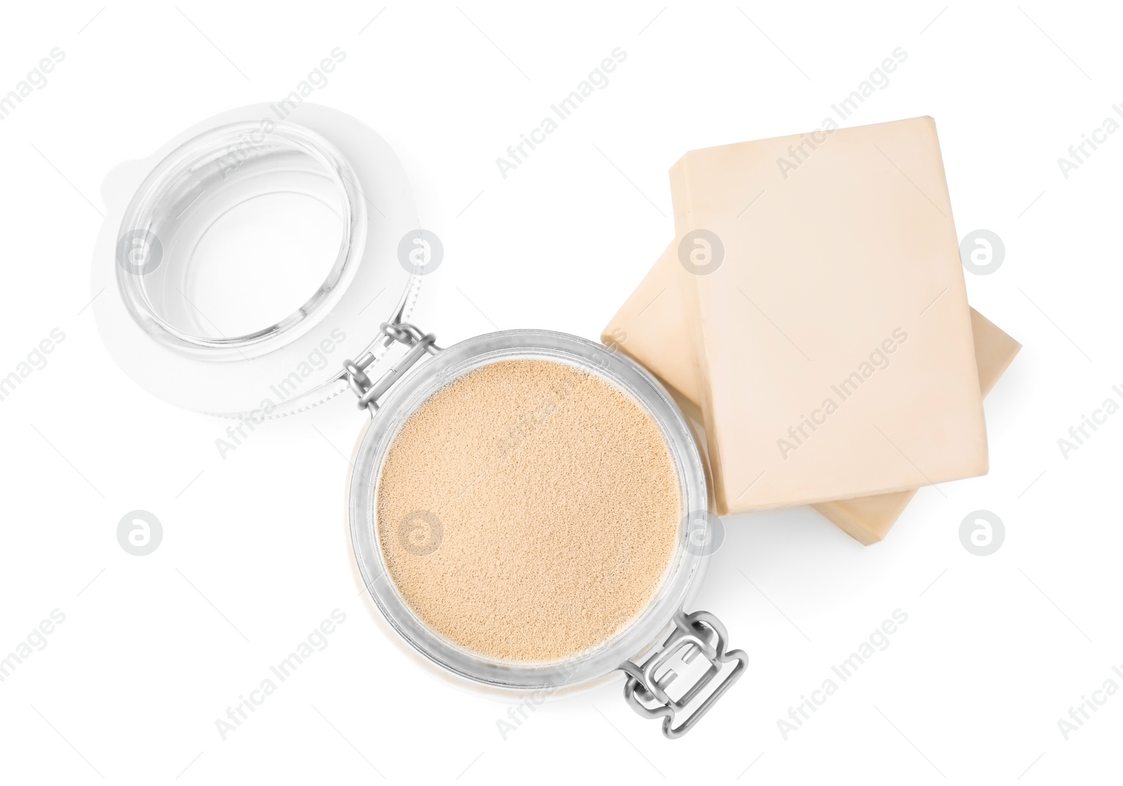 Photo of Compressed and granulated yeast on white background, top view