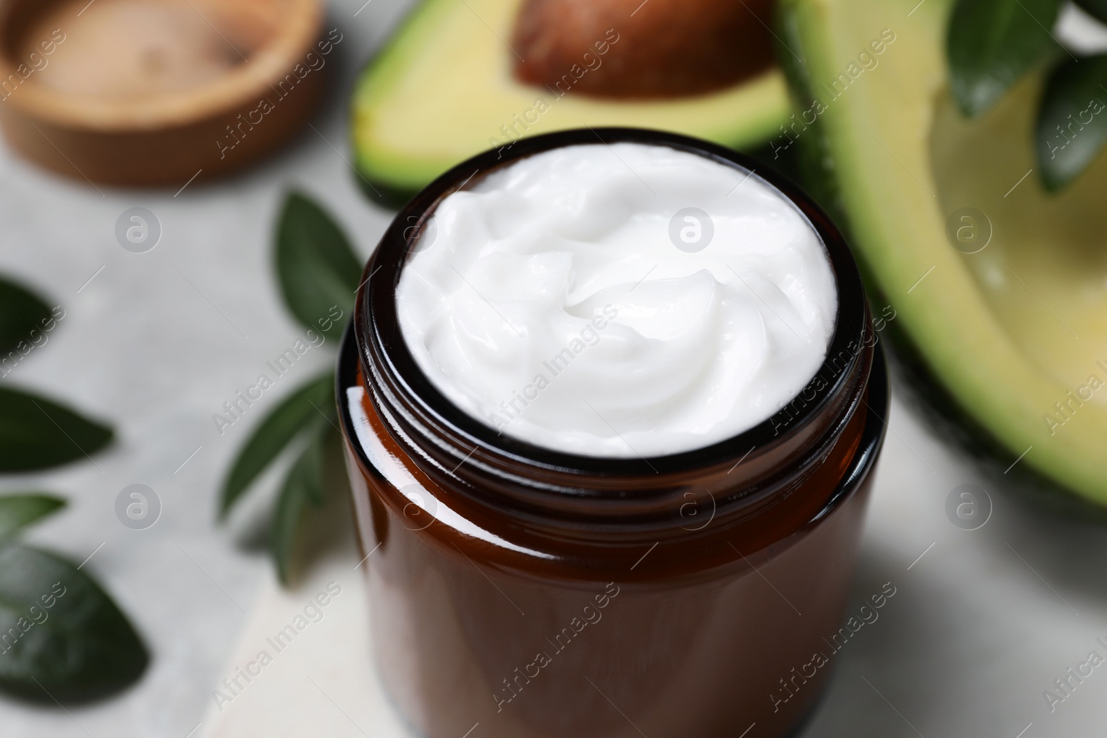 Photo of Jar of face cream on light grey table, closeup