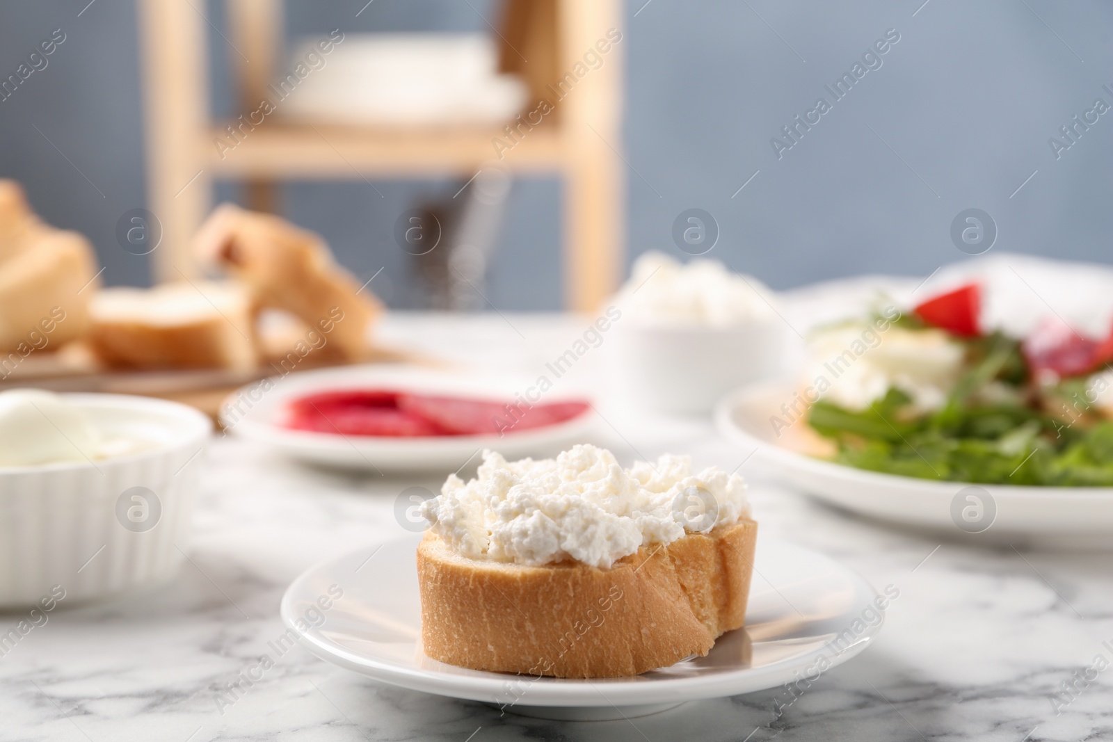 Photo of Delicious bruschetta with cheese on white marble table