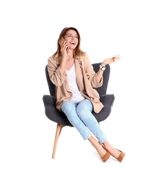 Photo of Young woman talking on phone in armchair against white background