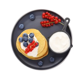 Photo of Tasty pancakes with natural yogurt, blueberries and red currants on white background