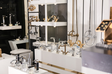 New shiny faucets in bathroom fixtures store. Total wholesale