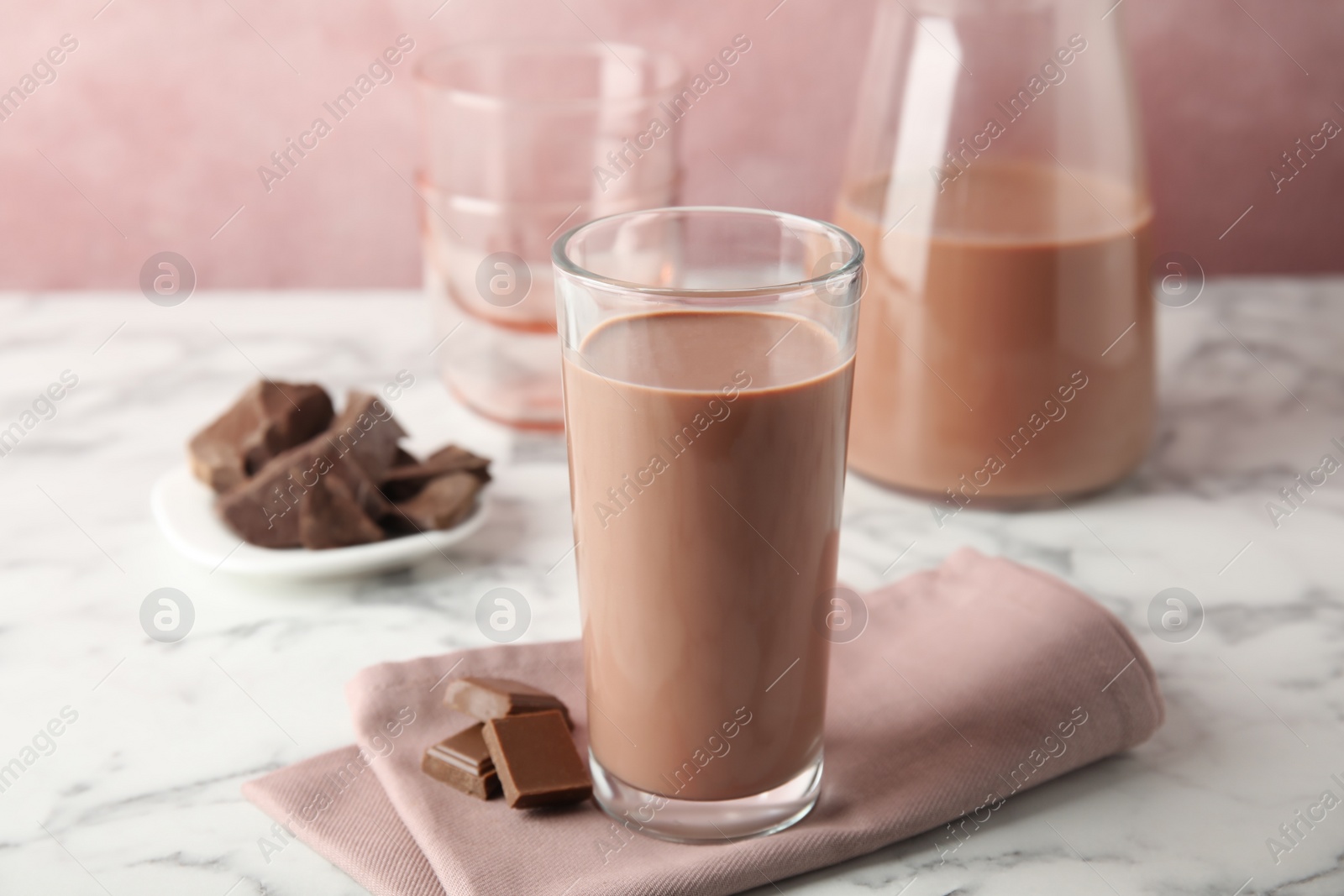 Photo of Glass with tasty chocolate milk on marble table. Dairy drink