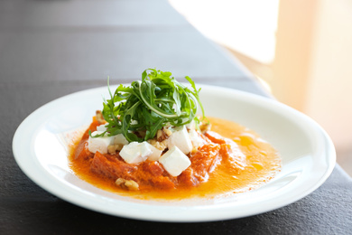 Photo of Delicious roasted pepper with feta cheese and arugula on plate