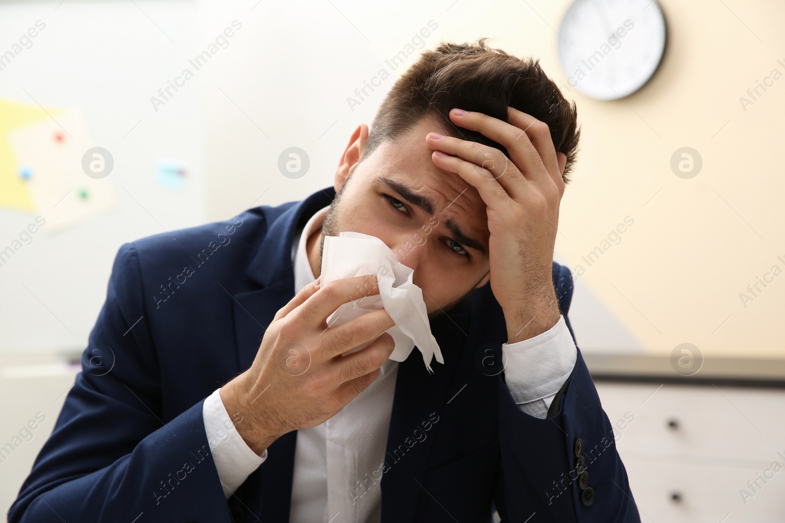 Photo of Sick young man at workplace. Influenza virus