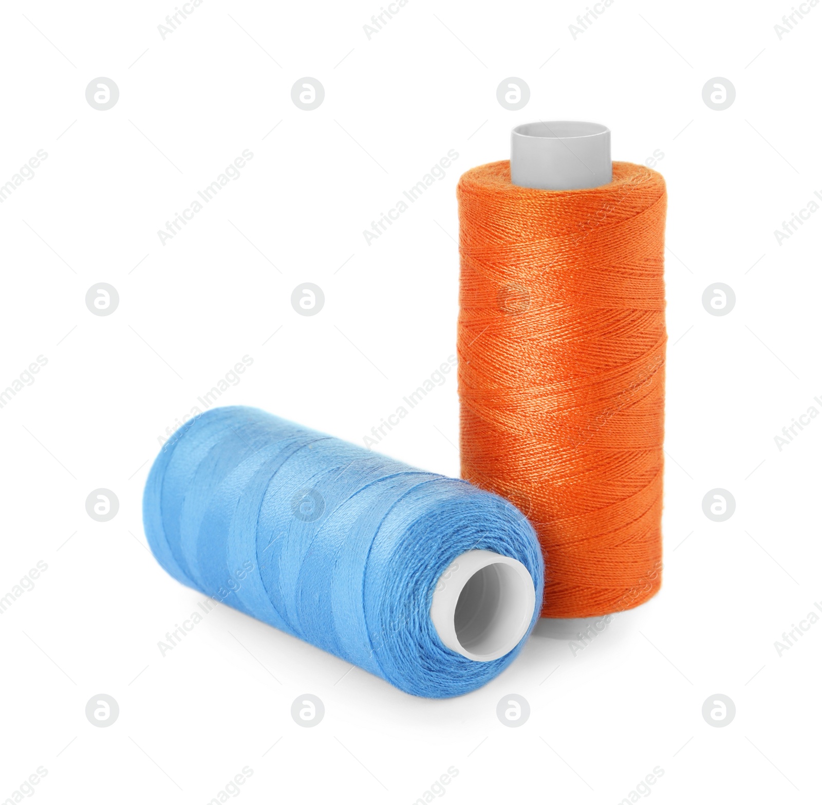 Photo of Different colorful sewing threads on white background