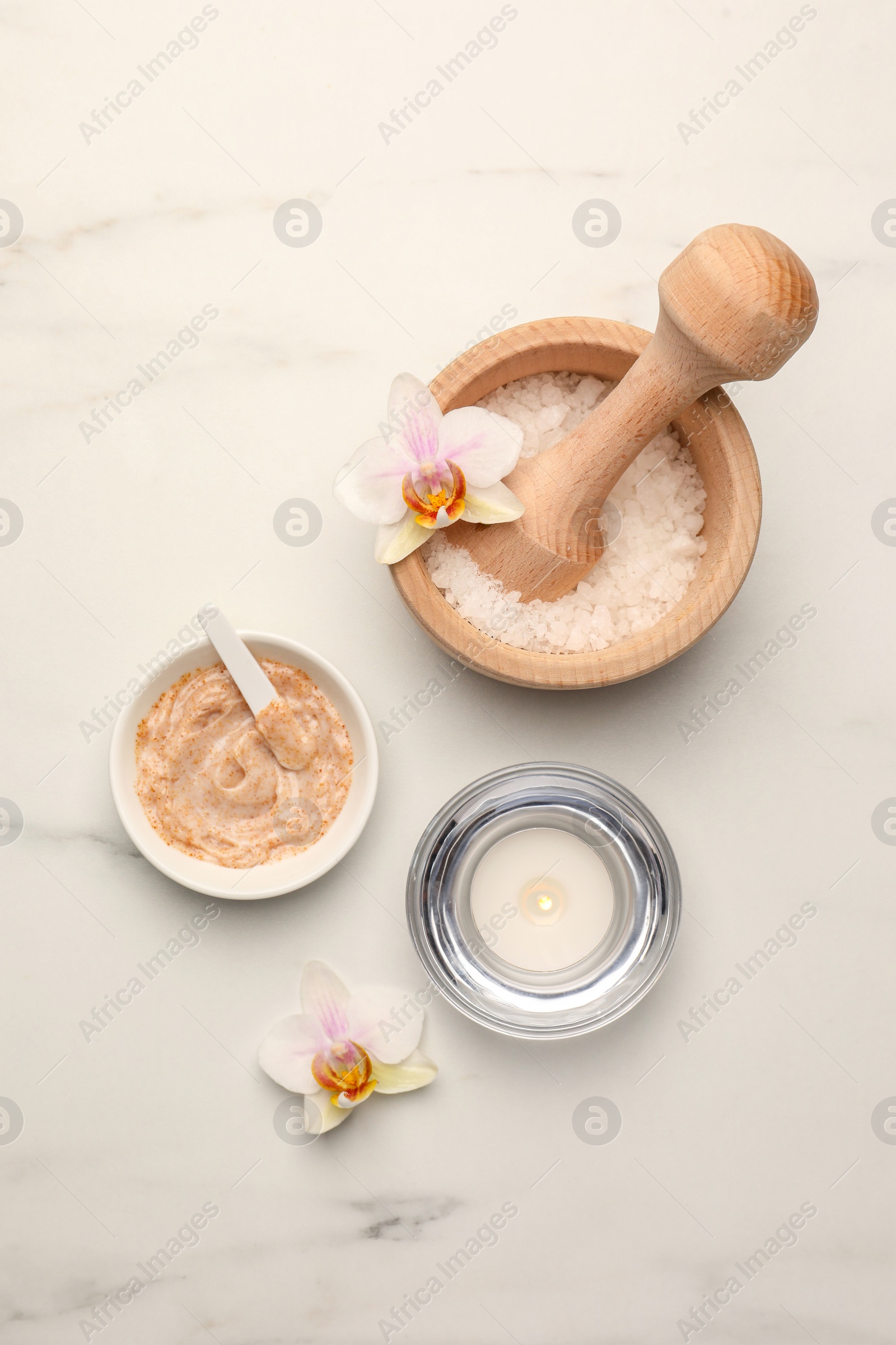 Photo of Flat lay composition with different spa products and flowers on white marble table