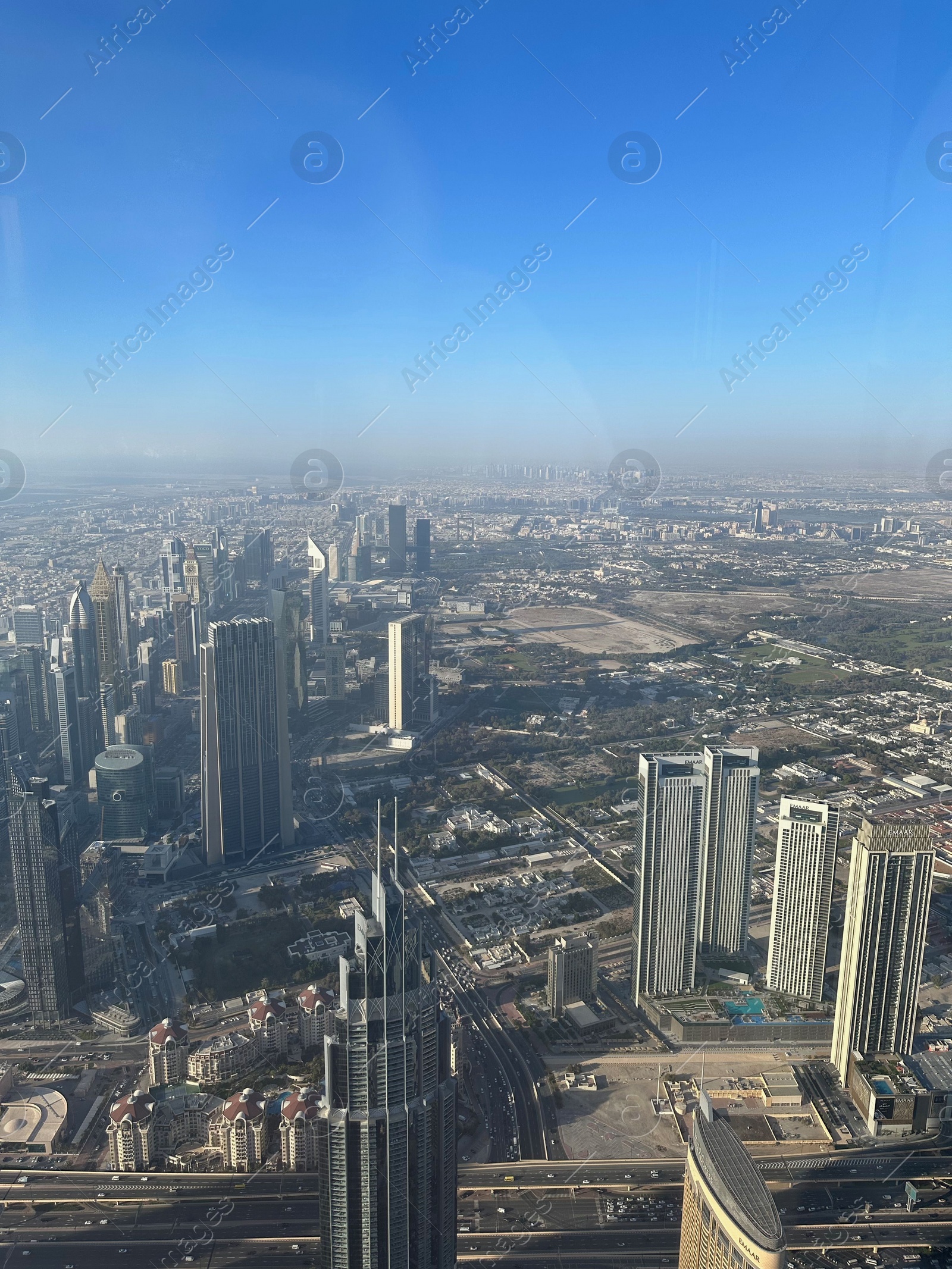 Photo of Dubai, United Arab Emirates - May 2, 2023: Picturesque view of city with skyscrapers from Burj Khalifa