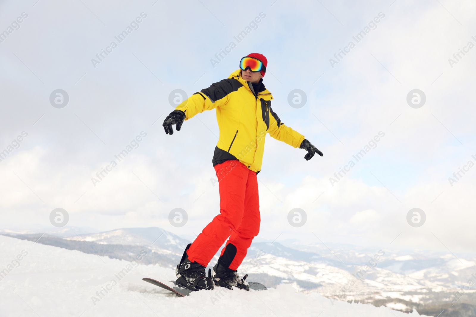 Photo of Male snowboarder on snowy hill. Winter vacation