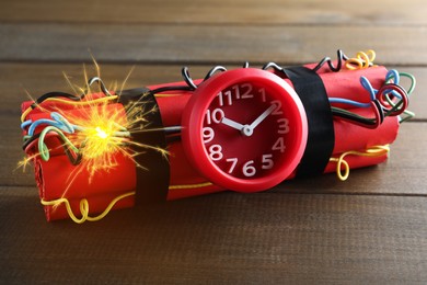 Image of Dynamite time bomb with burning wires on wooden table