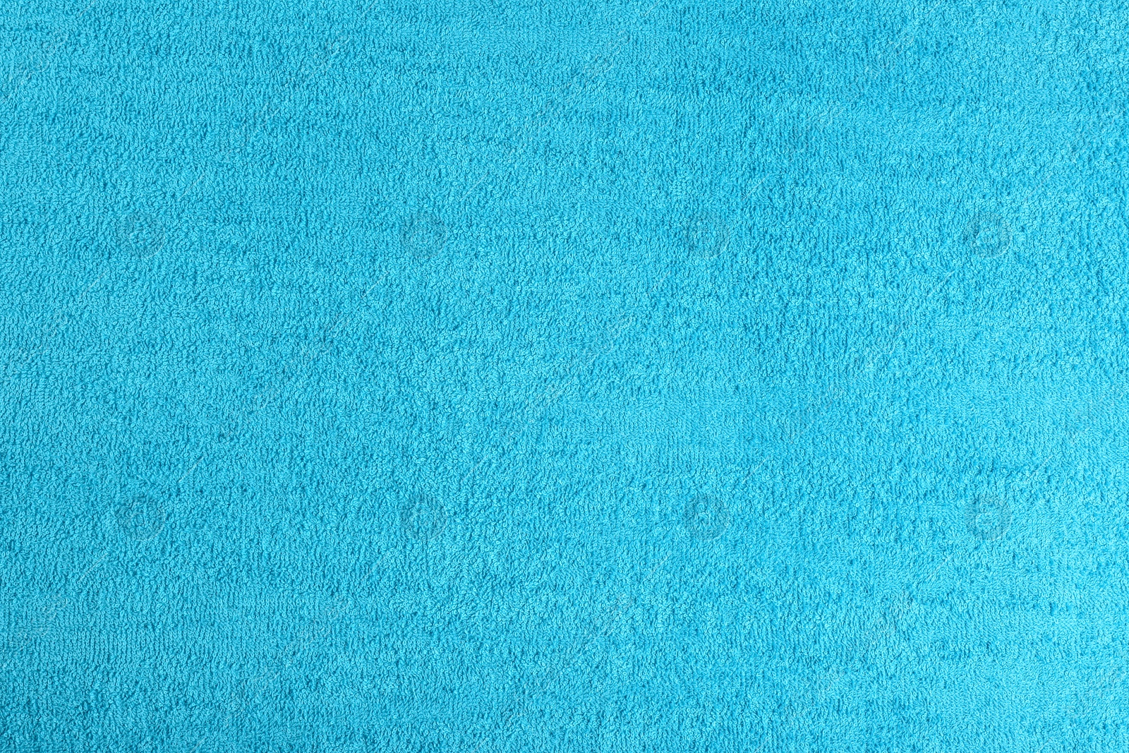 Photo of Clean light blue beach towel as background, closeup