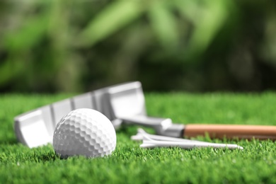 Set of golf equipment on green artificial grass