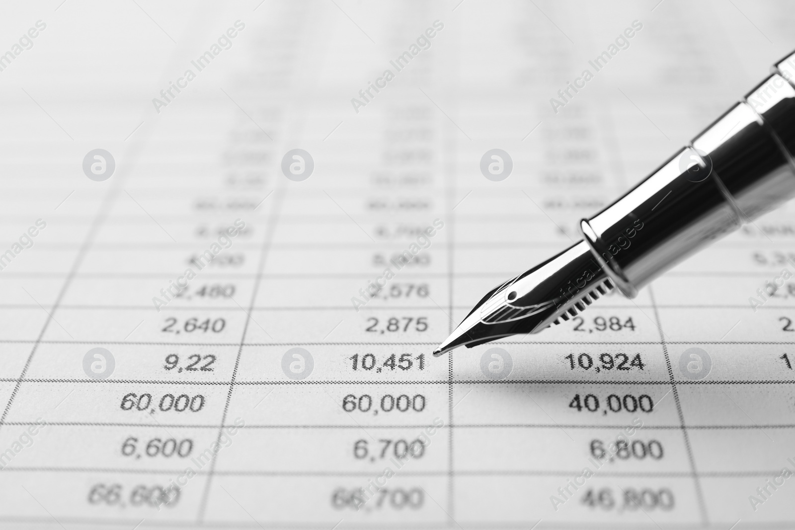 Photo of Fountain pen and accounting document with data, closeup. Space for text