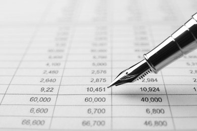 Fountain pen and accounting document with data, closeup. Space for text