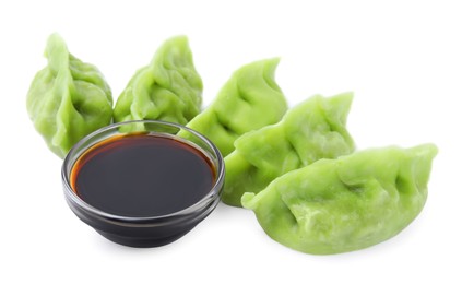 Delicious green dumplings (gyozas) and soy sauce isolated on white