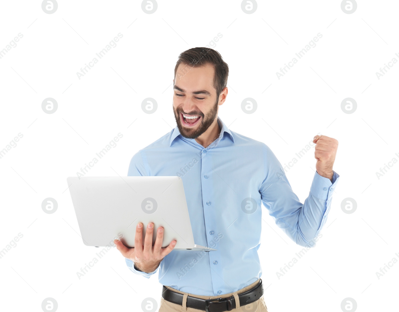 Photo of Emotional young man with laptop celebrating victory on white background