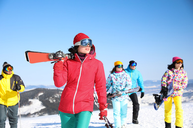 Young woman with ski at resort. Winter vacation