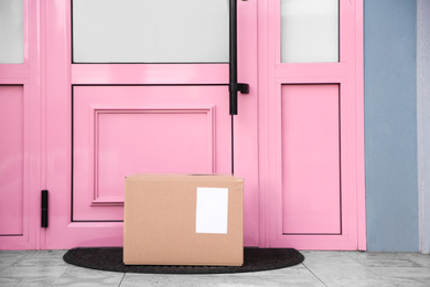 Photo of Delivered parcel on door mat near entrance