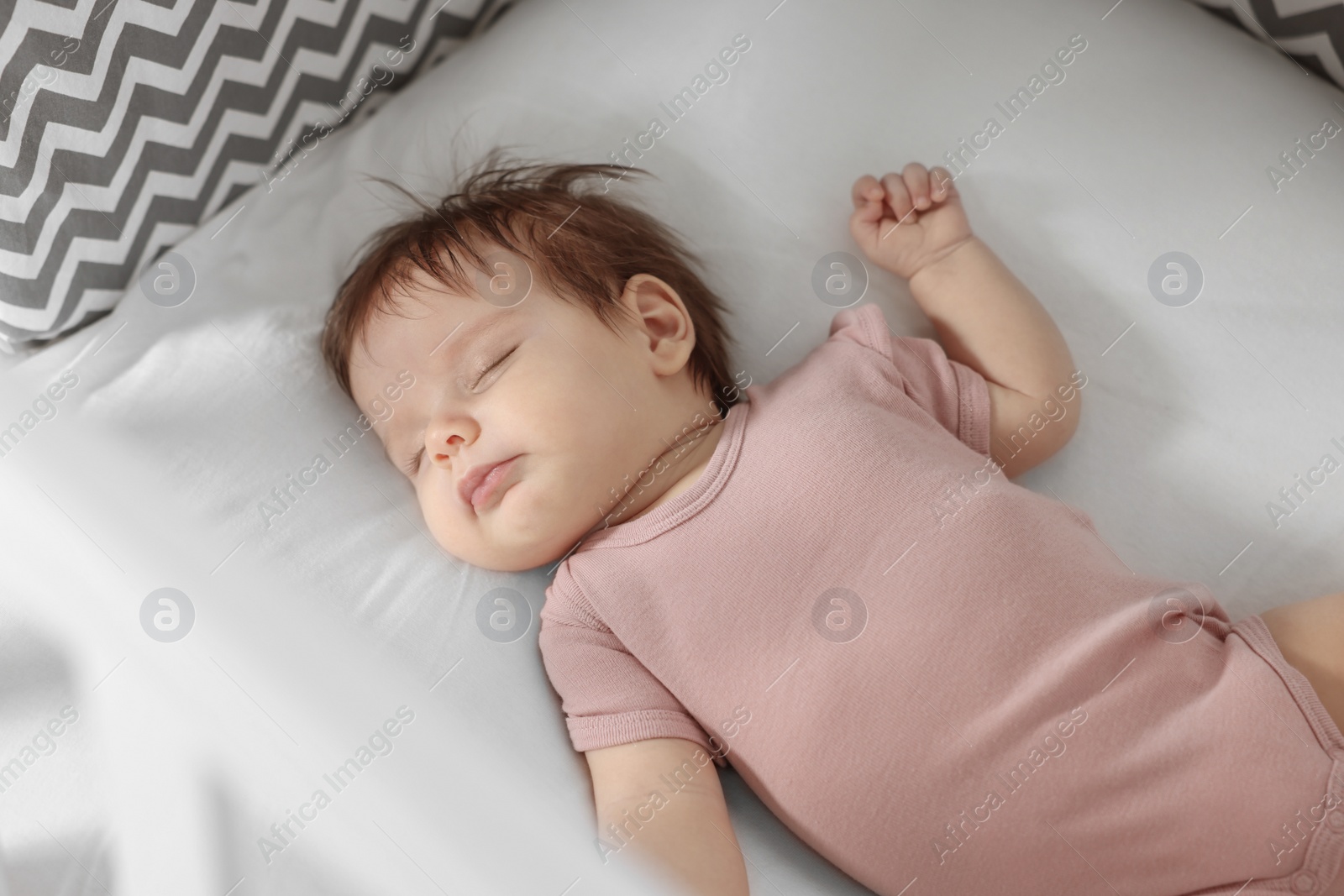 Photo of Cute little baby sleeping on cosy bed