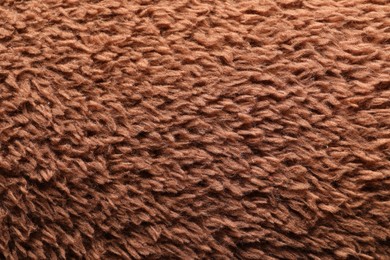 Texture of brown faux fur as background, closeup