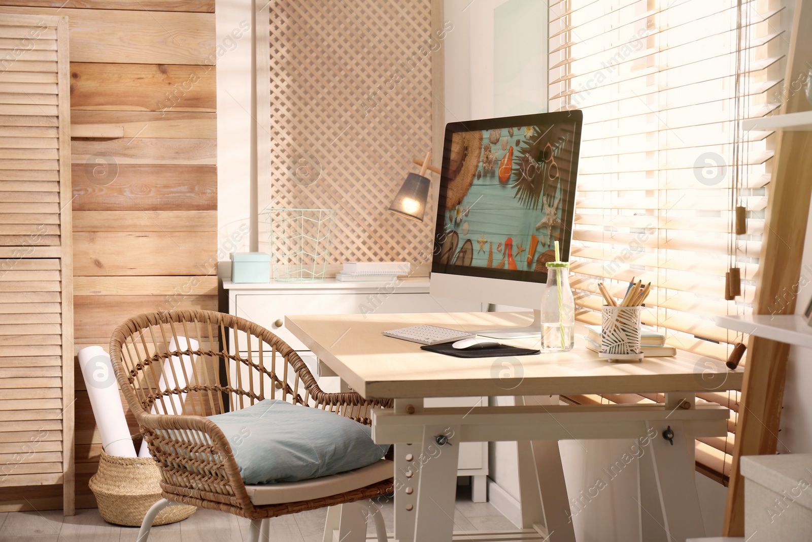 Photo of Comfortable workplace with modern computer near window. Interior design