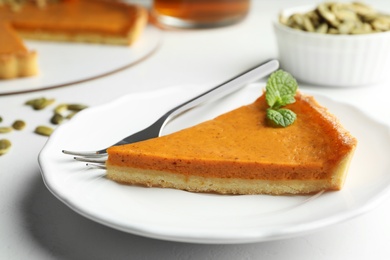 Photo of Piece of delicious fresh homemade pumpkin pie on white table