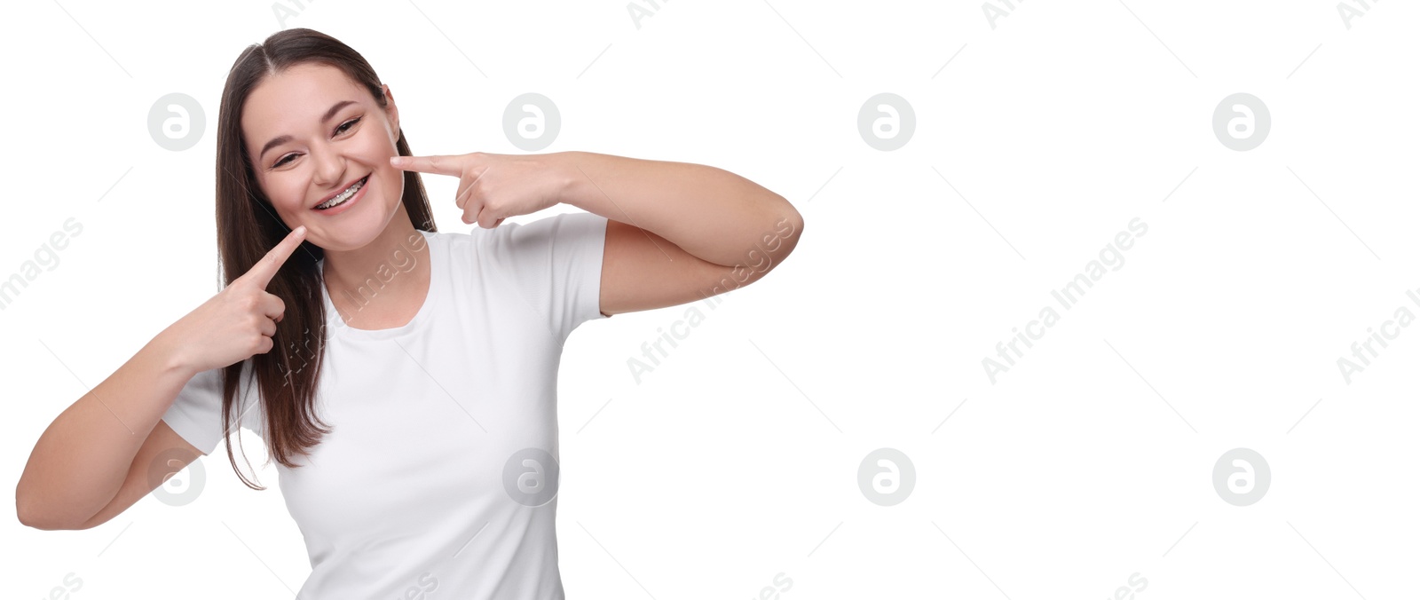 Image of Smiling woman pointing at her braces on white background. Banner design with space for text