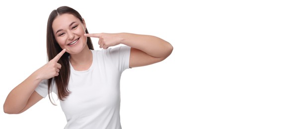 Image of Smiling woman pointing at her braces on white background. Banner design with space for text