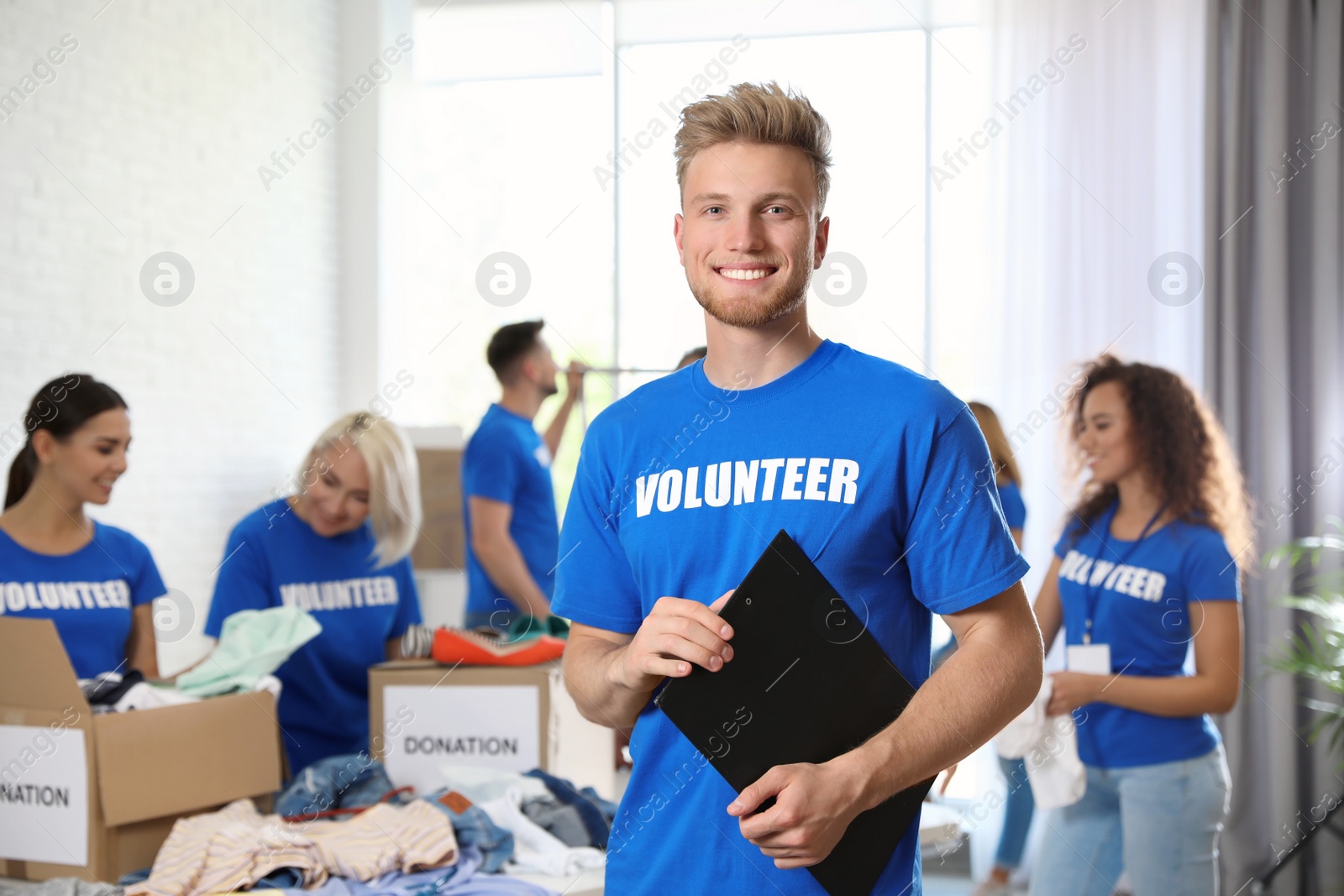 Photo of Portrait of happy male volunteer in uniform indoors