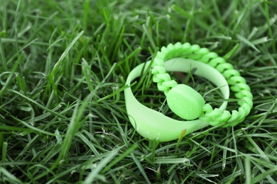 Insect repellent wrist bands on grass outdoors