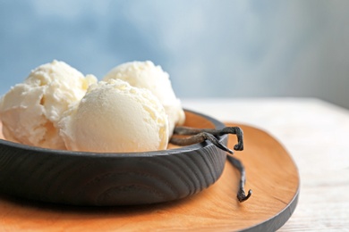 Photo of Plate with tasty vanilla ice cream on table