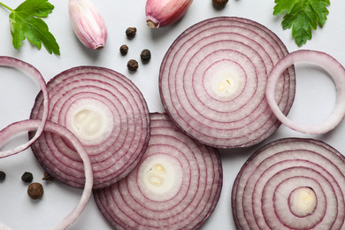 Photo of Flat lay composition with cut onion and spices on light background