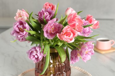 Beautiful bouquet of colorful tulip flowers on white marble table, closeup