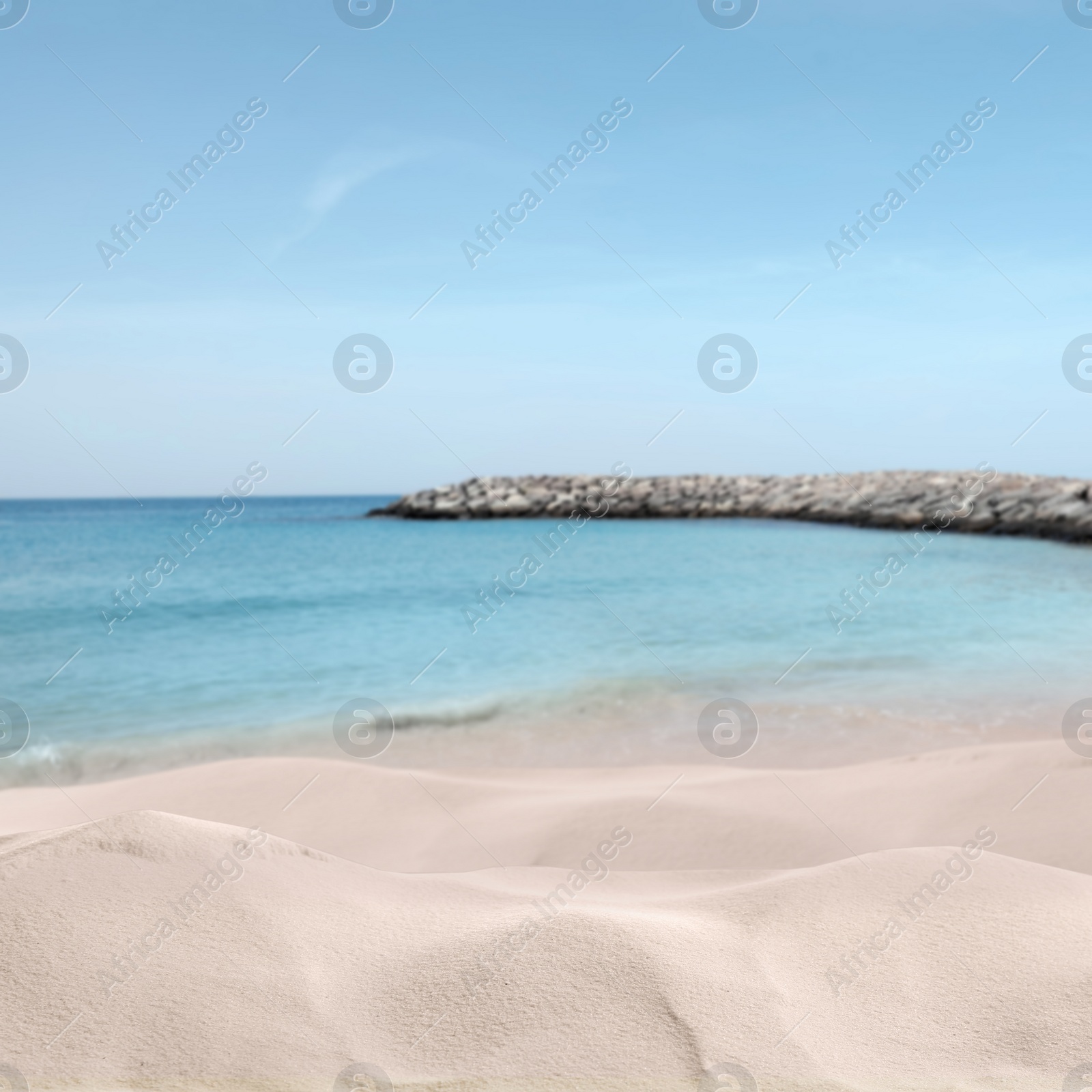 Image of Beautiful sandy beach near ocean under blue sky