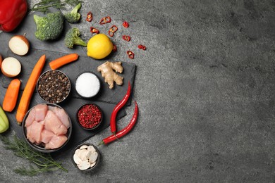 Photo of Different raw products and spices on grey table, flat lay. Space for text