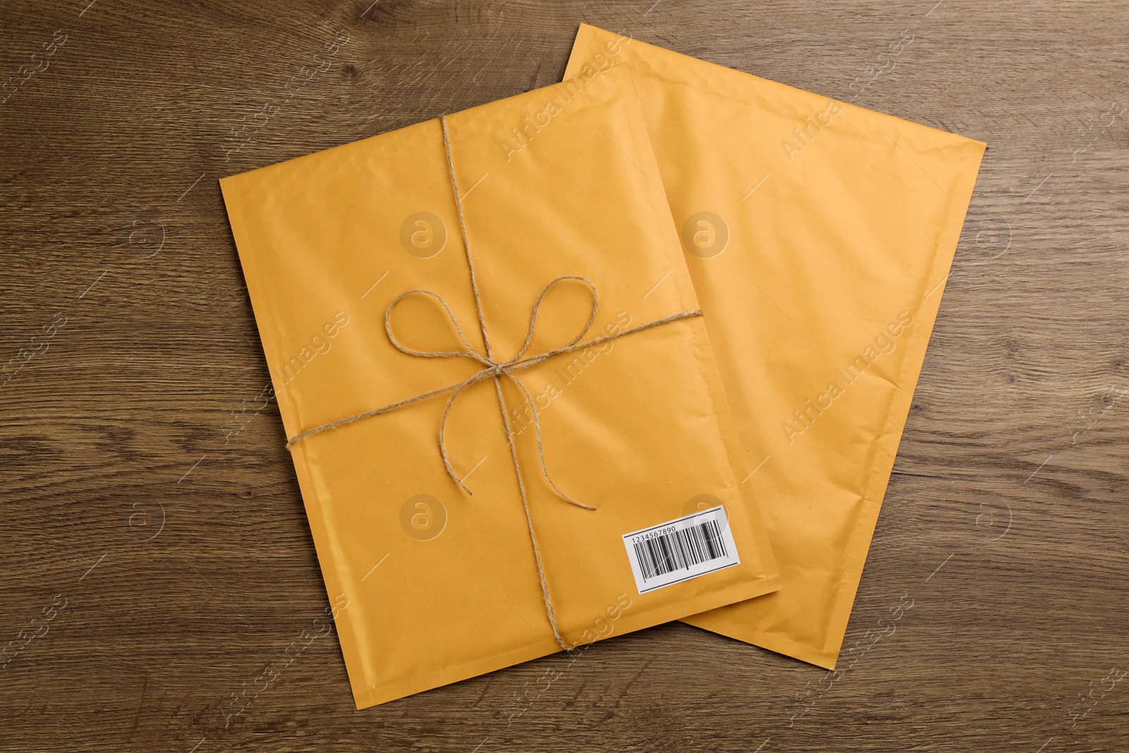 Photo of Padded envelopes on wooden background, flat lay