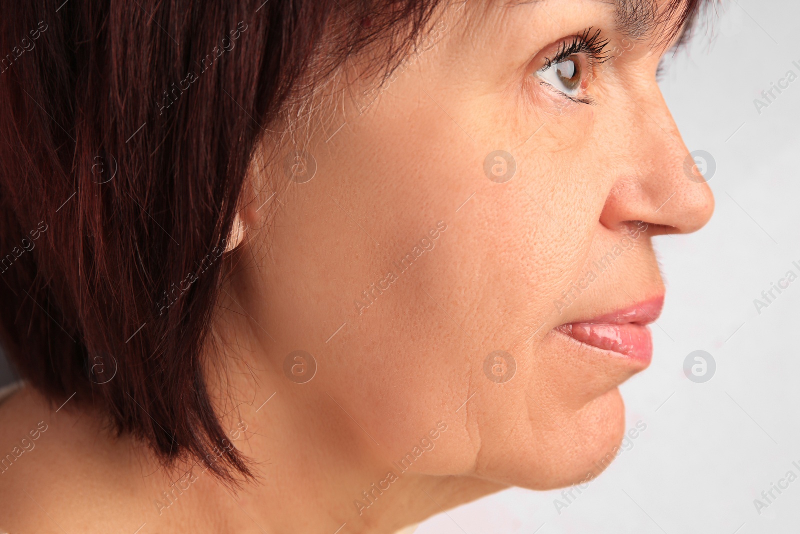 Photo of Closeup view of older woman on white background