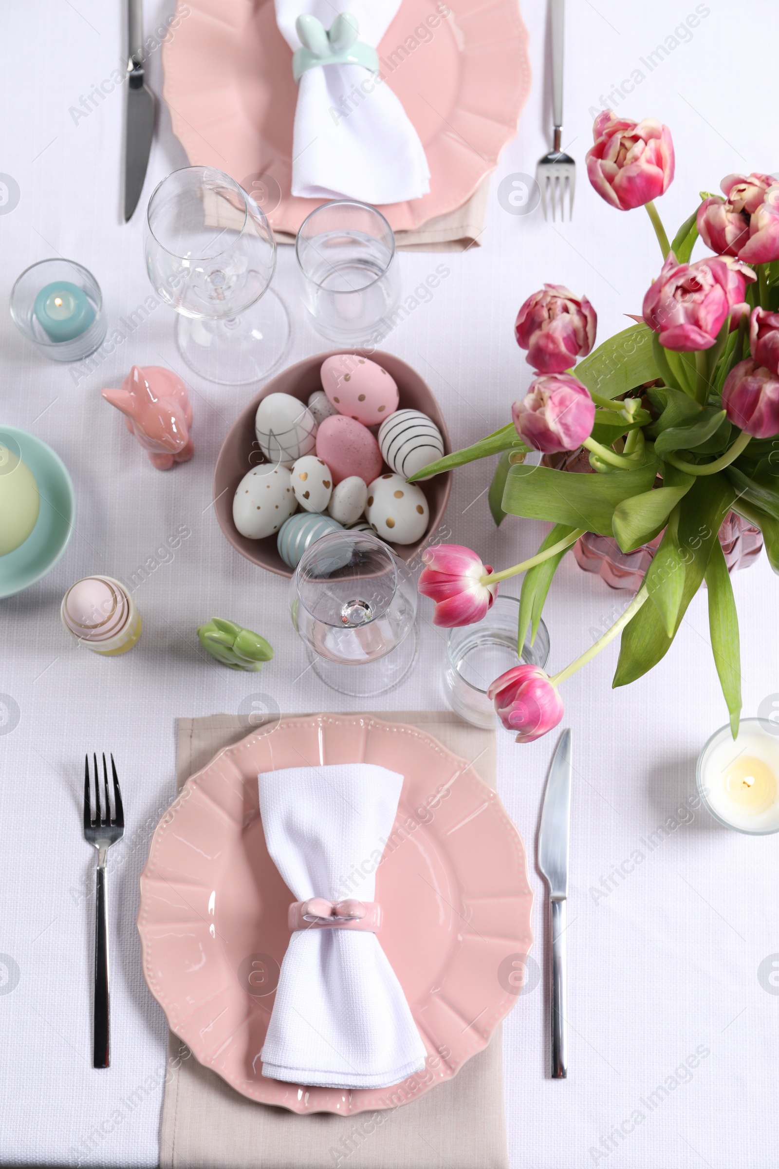 Photo of Festive table setting with beautiful flowers, flat lay. Easter celebration