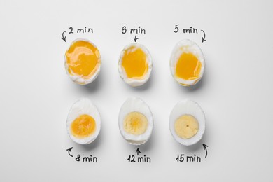 Different cooking time and readiness stages of boiled chicken eggs on white background, flat lay