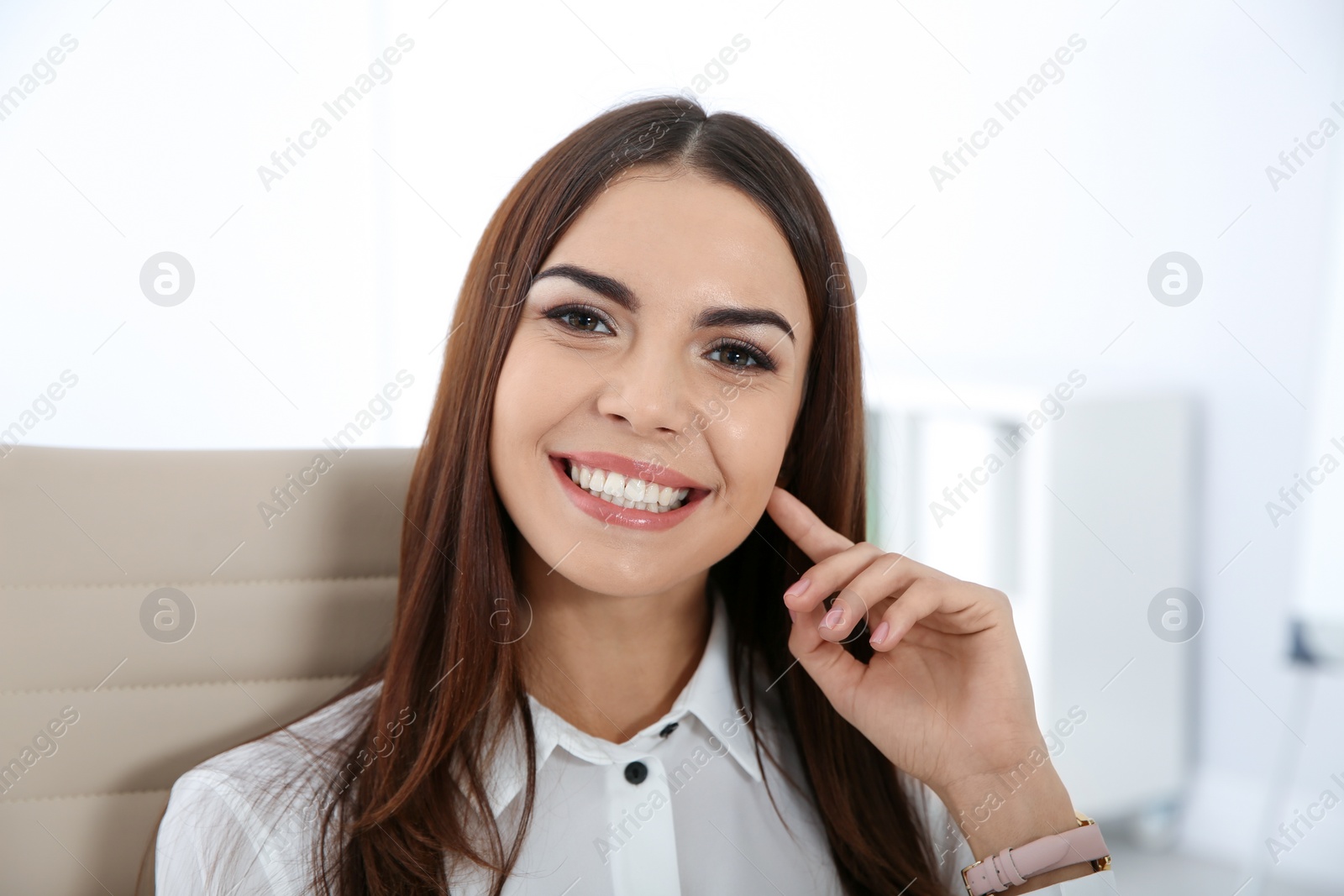 Photo of Portrait of young businesswoman laughing at workplace