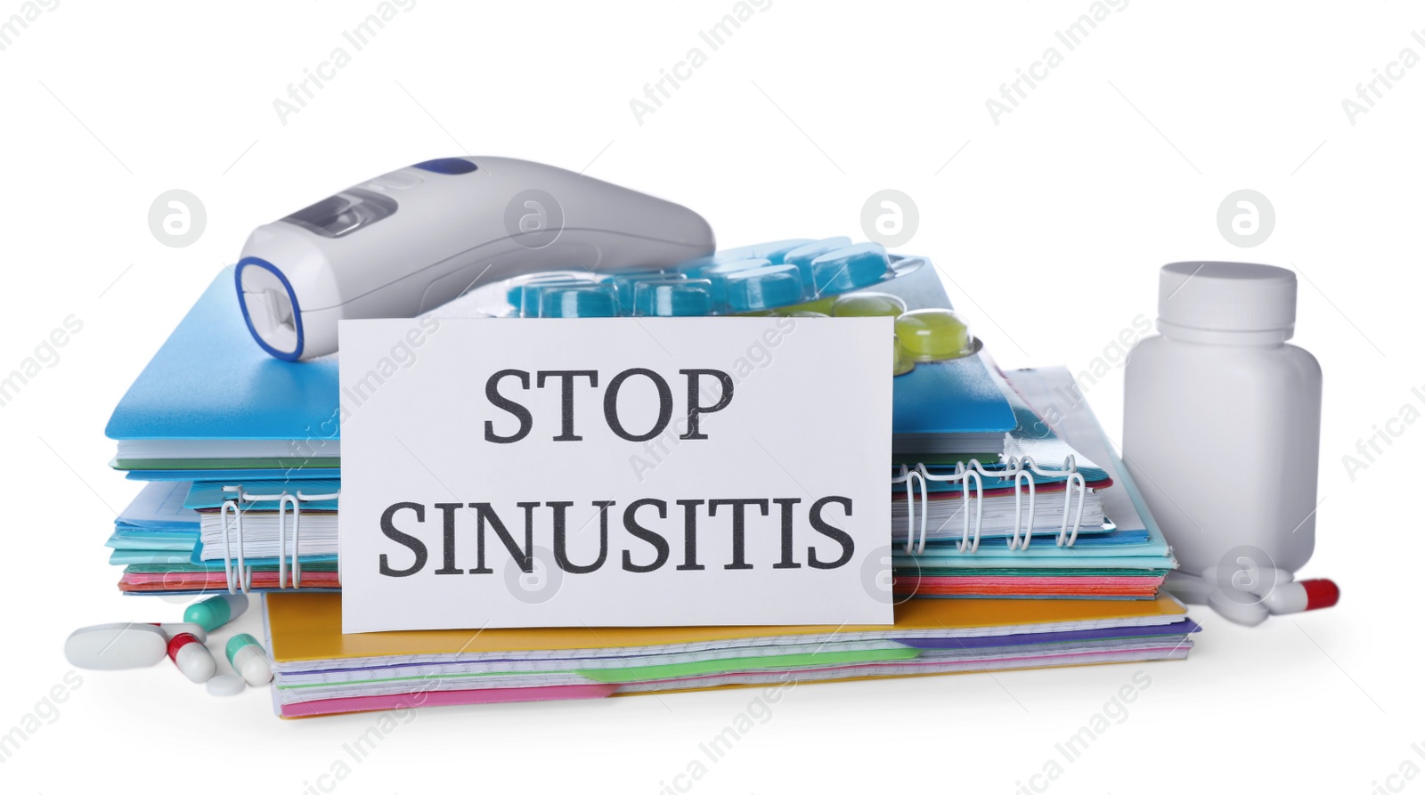 Photo of Card with phrase STOP SINUSITIS, non-contact thermometer and different drugs on white background