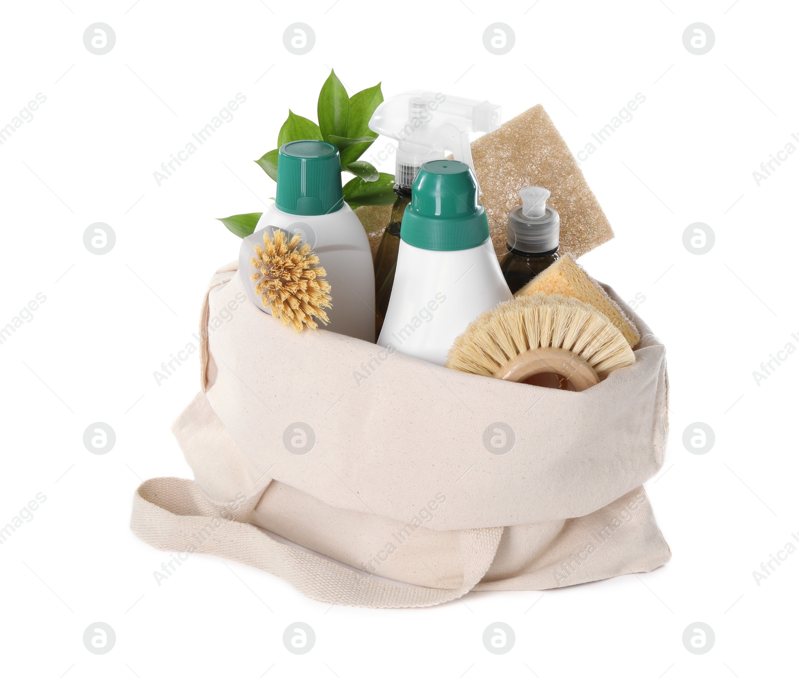 Photo of Bottles of cleaning product, brushes, sponges and green leaves in eco bag isolated on white