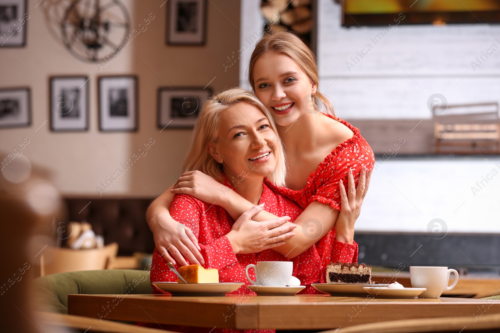 Photo of Mother and her adult daughter spending time together in cafe