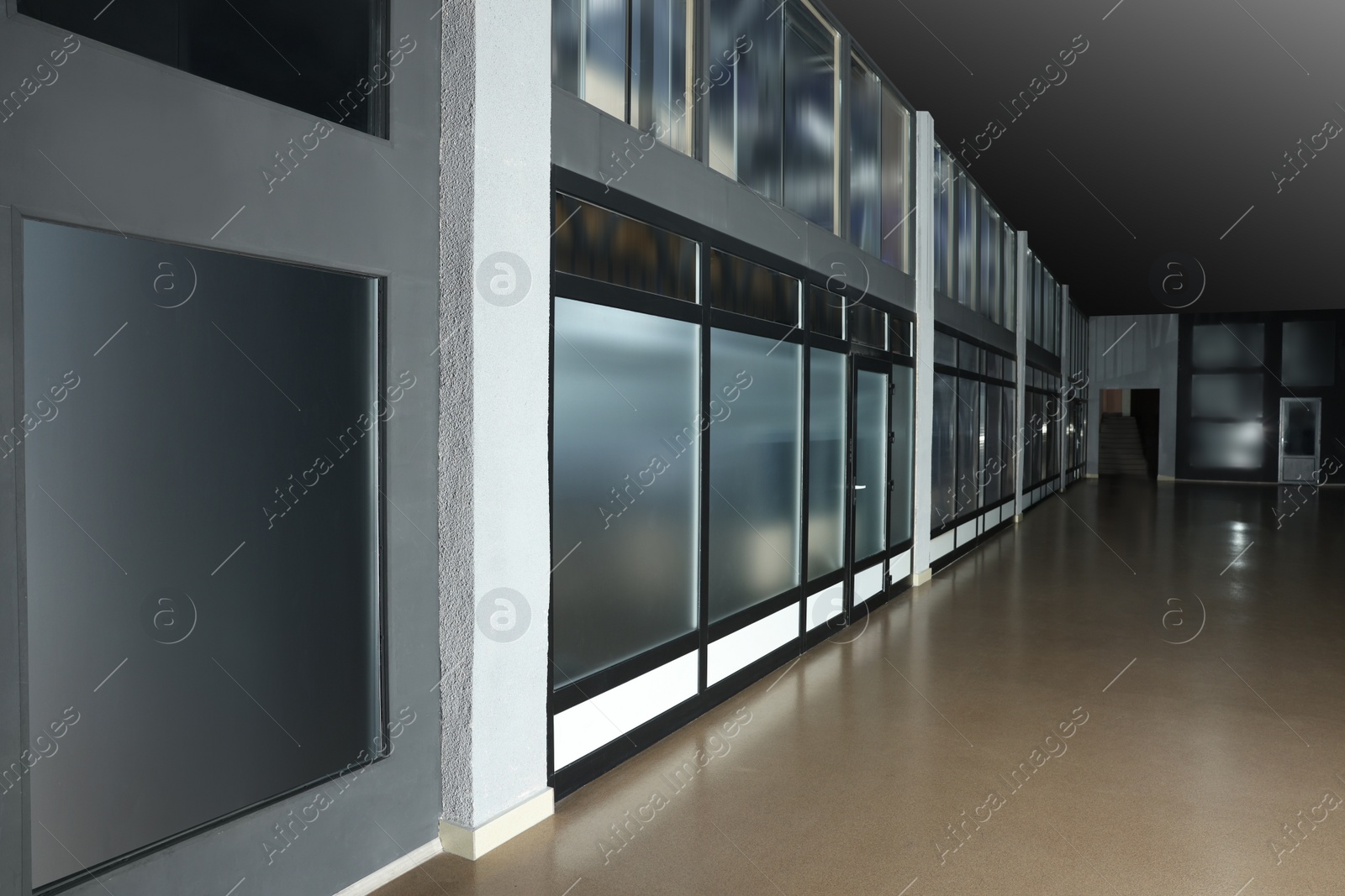 Photo of Modern empty office corridor with glass wall