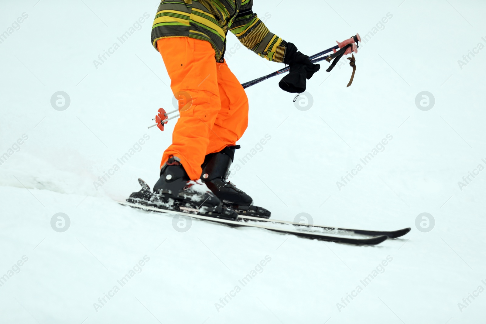 Photo of Skier on slope at resort, closeup. Winter vacation