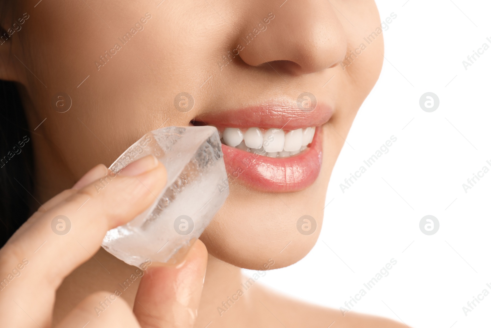 Photo of Young woman with ice cube on white background, closeup. Skin care