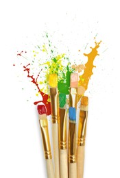 Image of Different brushes and paint splatters on white background, top view