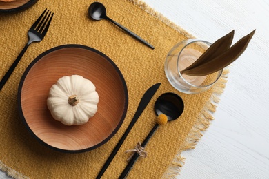 Photo of Autumn table setting with pumpkin on white wooden background, flat lay