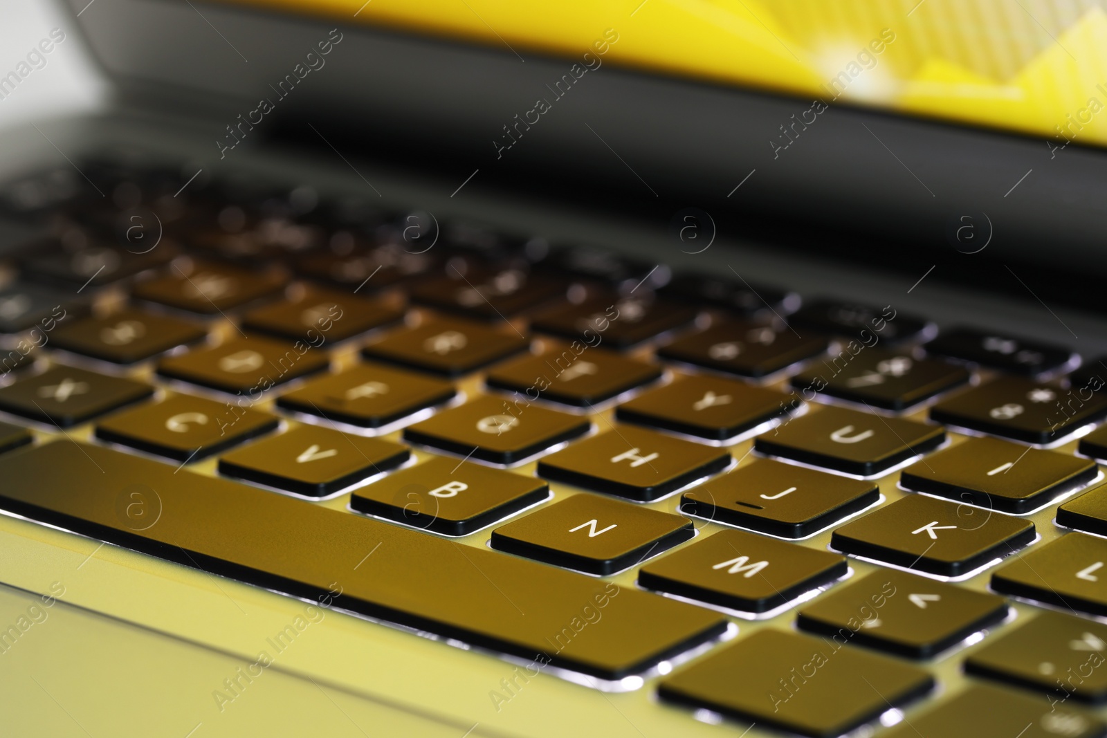 Photo of Closeup view of modern laptop keyboard as background